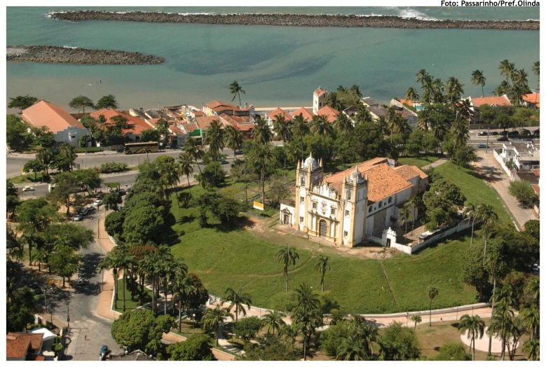 an aerial view of a house on the water