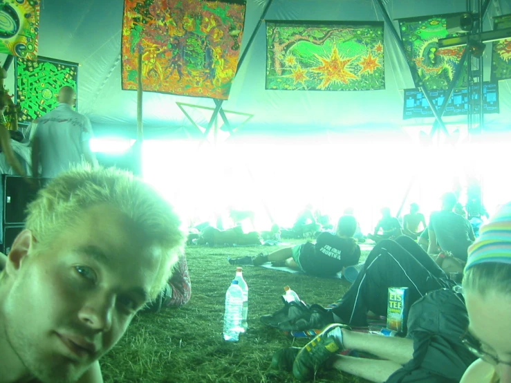 three guys sitting in front of paintings and lights