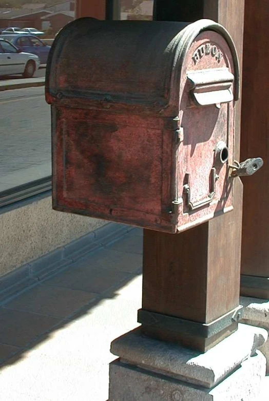 the wooden mailbox is in front of a building