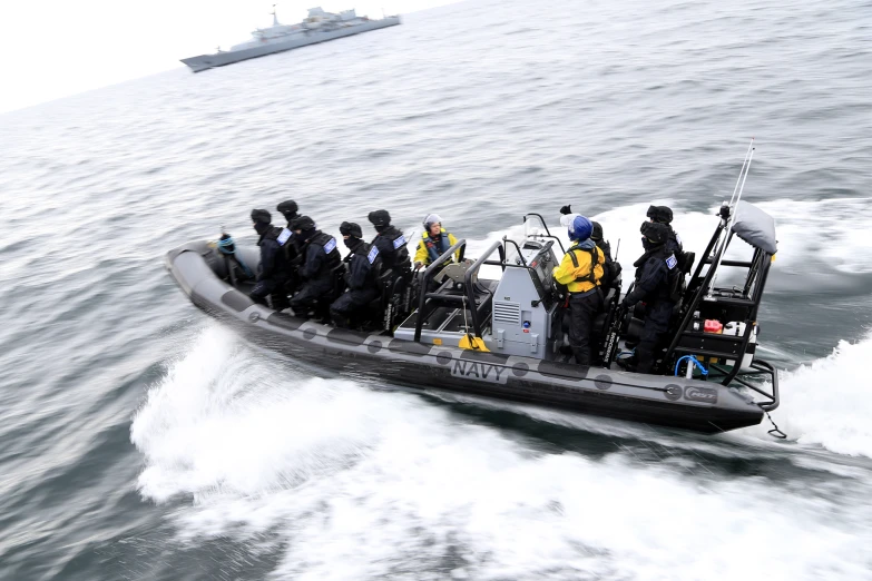 a group of people are in the back of a speedboat