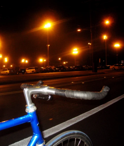 a bicycle parked on a city street at night