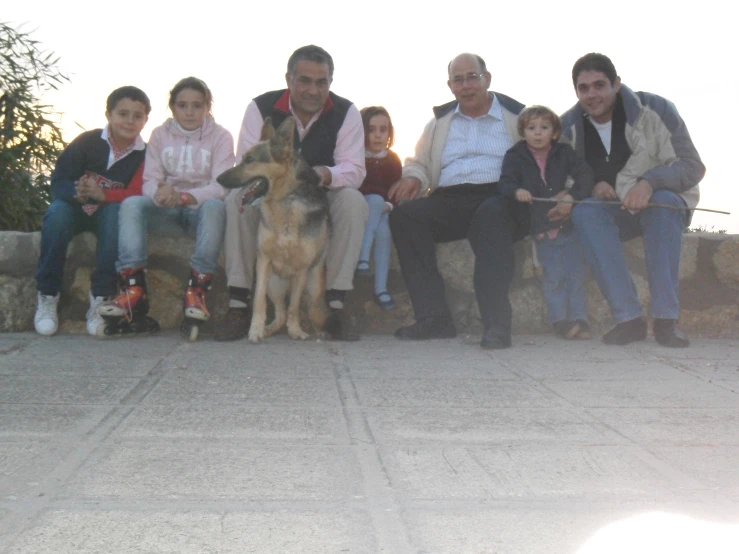 a group of people sitting down with a dog