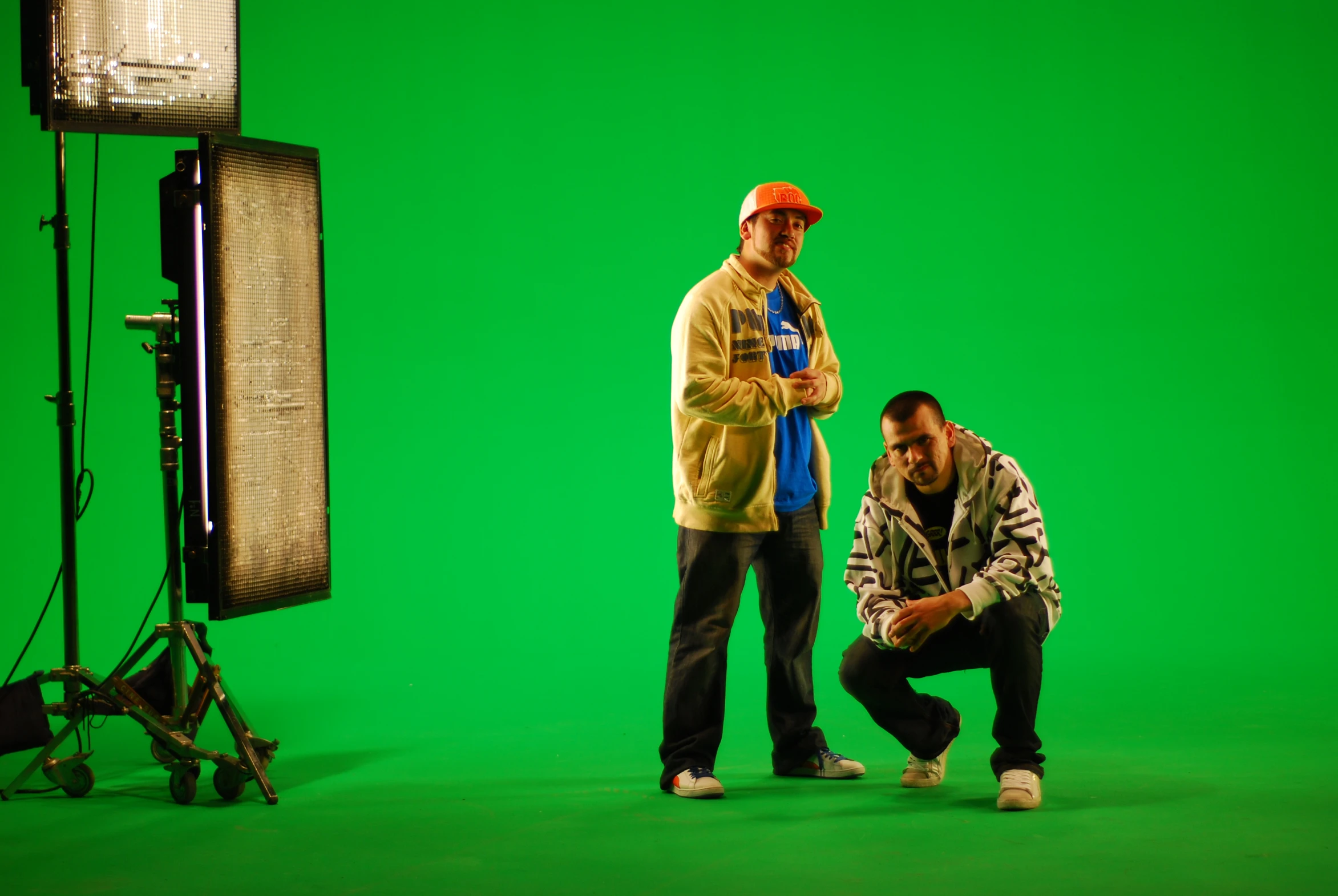 a man and another man standing together in front of green screen