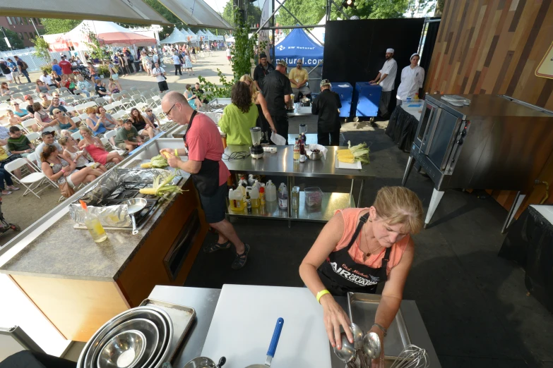 an outdoor food court with people waiting