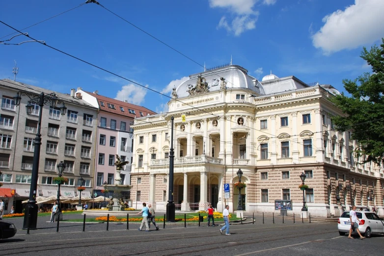 a large, white building next to a busy street