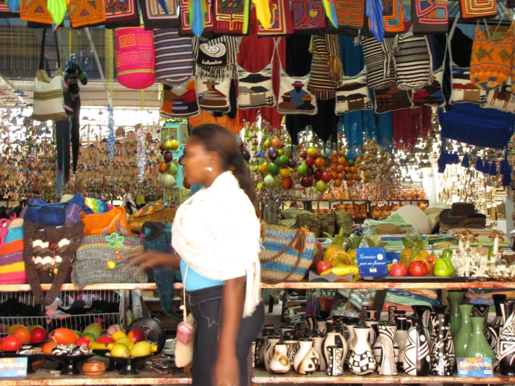 woman in market with many accessories and purses