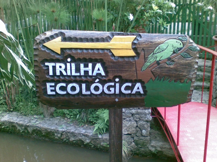 a sign with birds and a yellow arrow pointing to the side