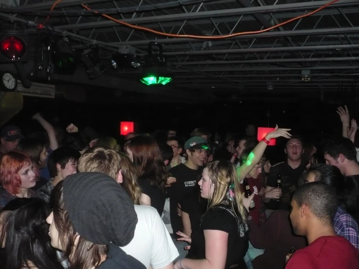 a group of people stand together in a nightclub