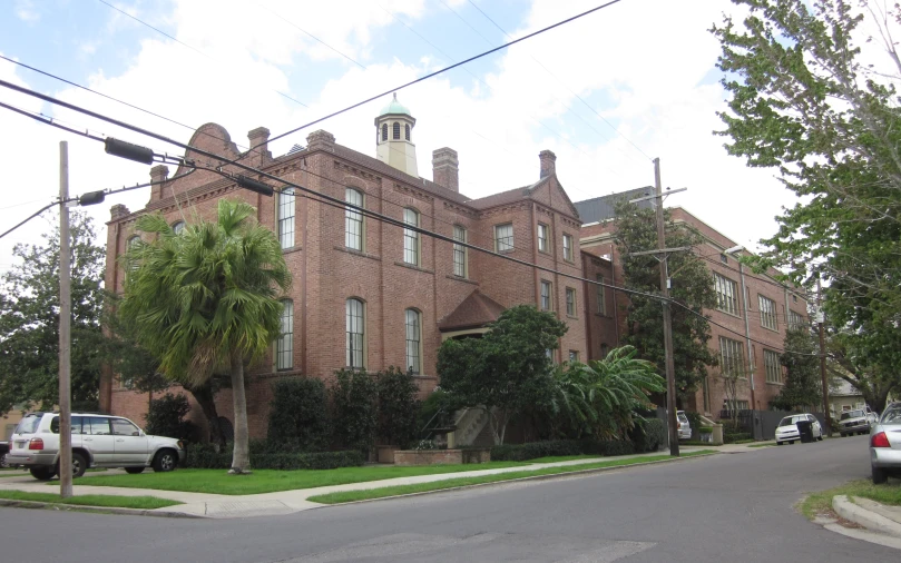 a tall brick building with trees on the side of it