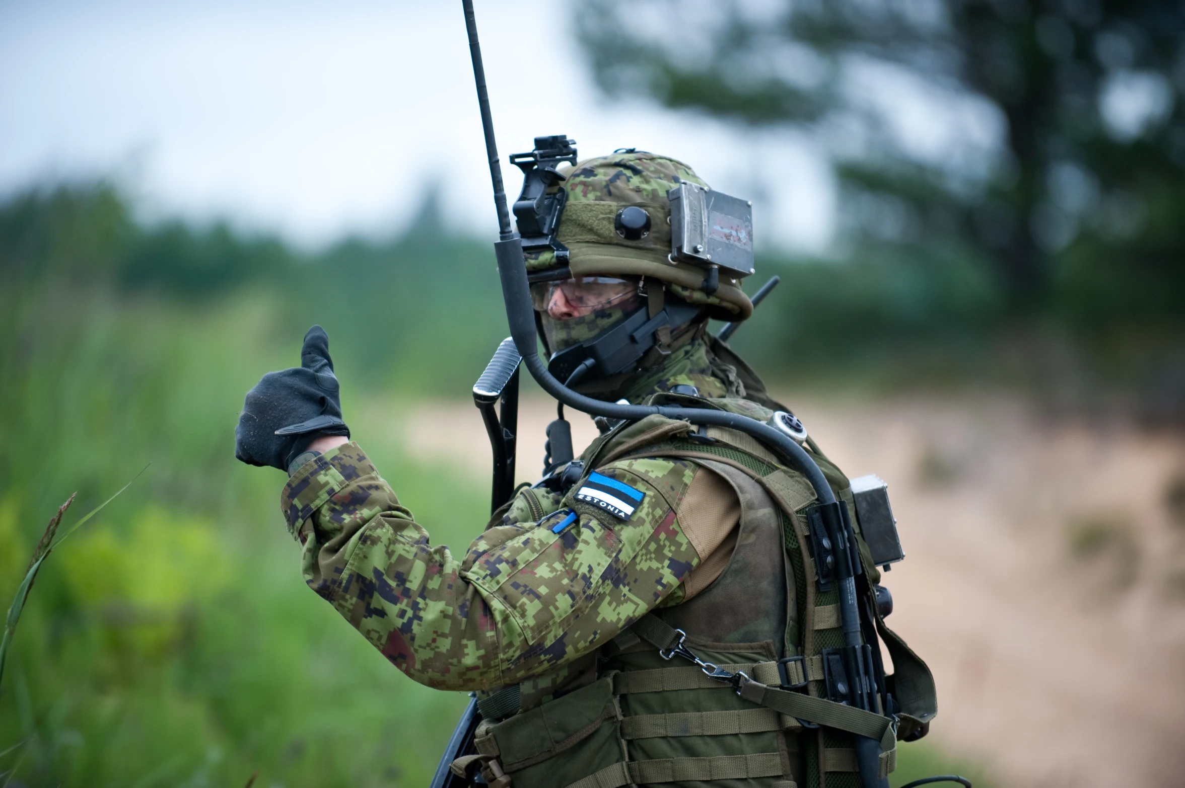 a person in camouflage holding up their rifle