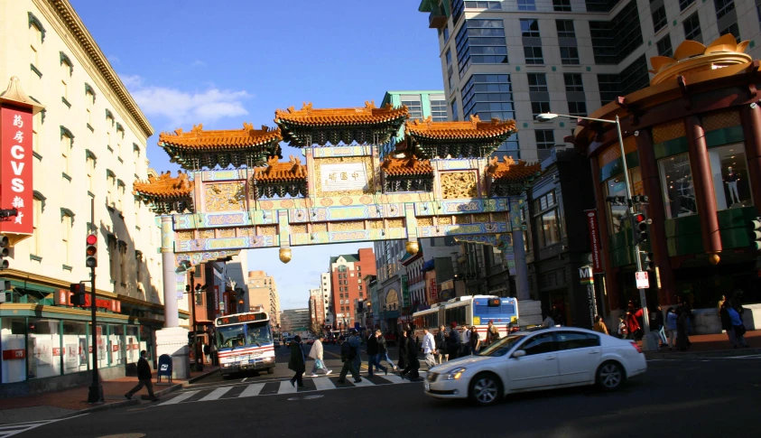 many people are walking near the buildings in town