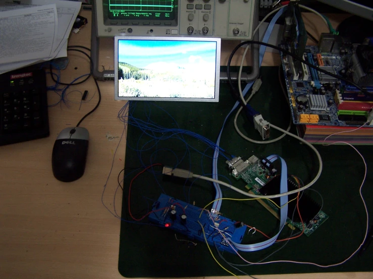 a view of an electronics table with mouse and monitor