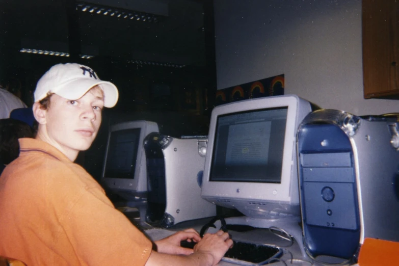 a young man sitting in front of a computer monitor