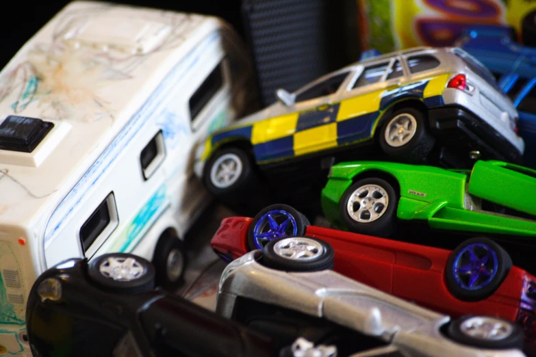 a toy assortment of cars and trucks are on a table