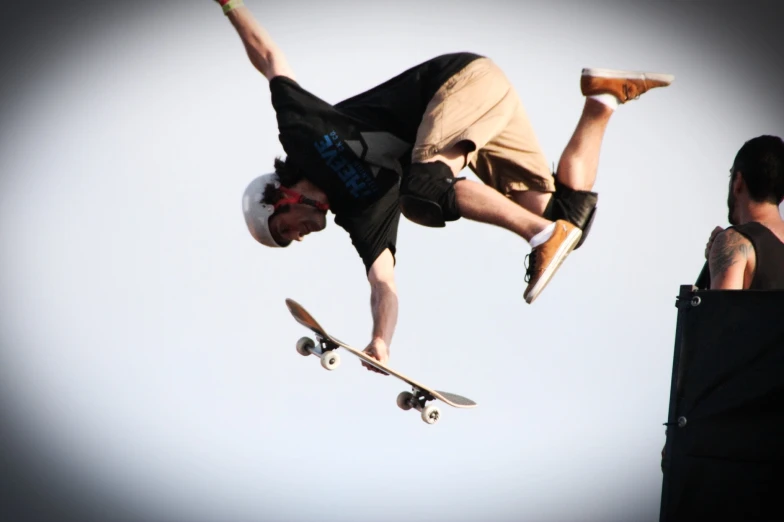 a man on a skateboard doing tricks in the air