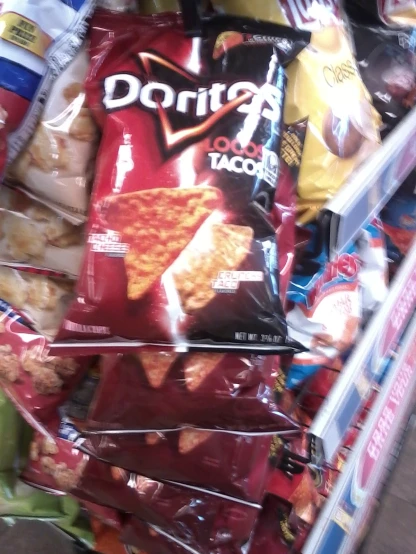 this is an image of bags of doritos on a grocery cart