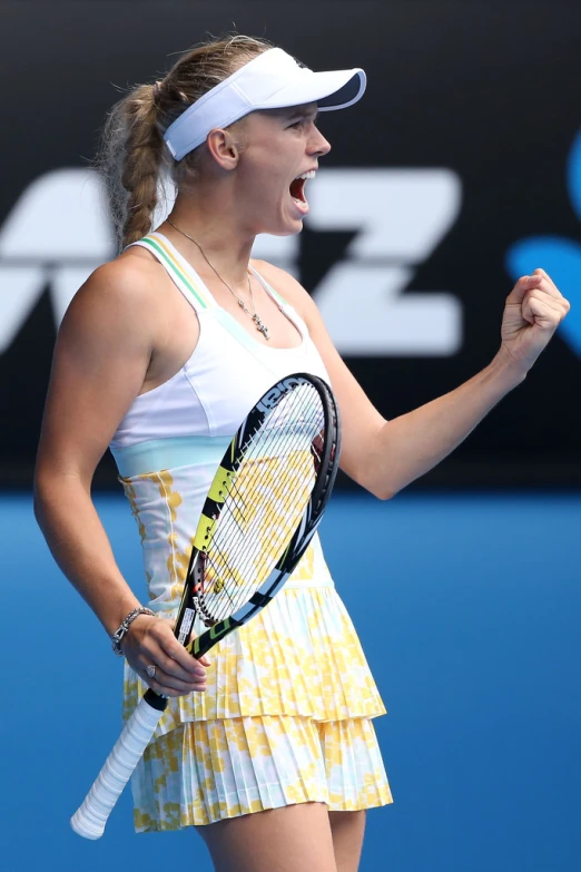 woman holding tennis racquet in her hand and laughing