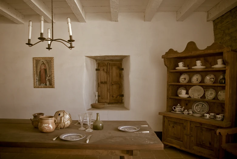 a table with plates and cups is against a white wall