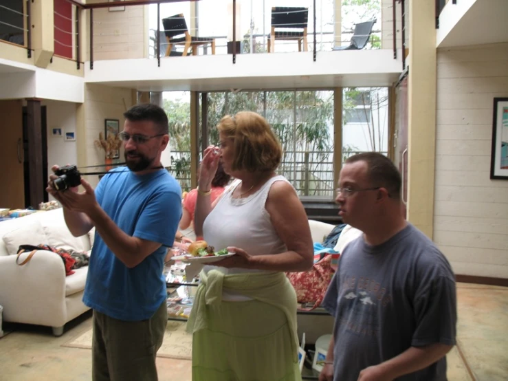 several people standing around a table talking to each other