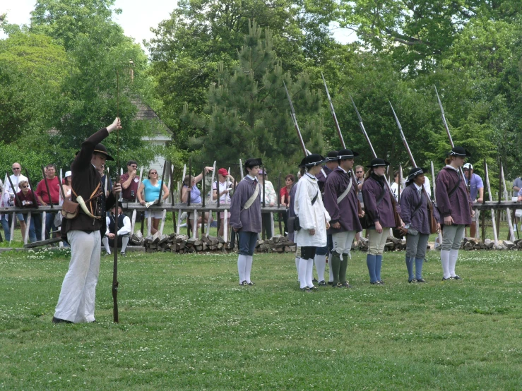 soldiers dressed in period dress saluting at battle