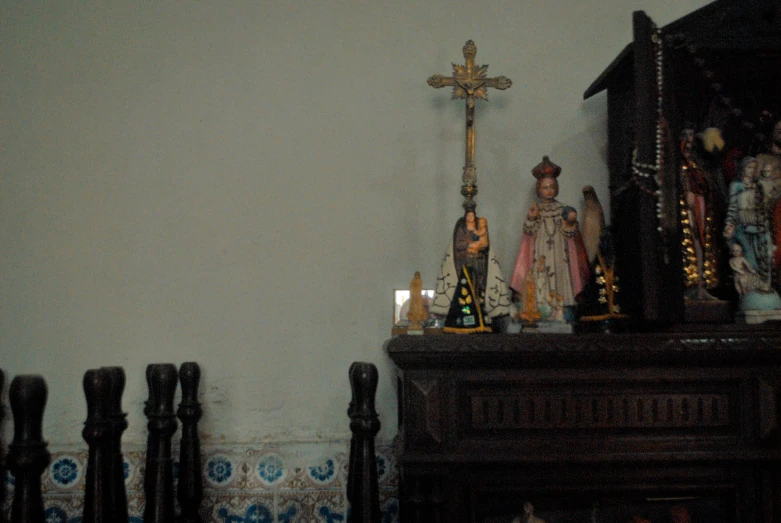 a shrine with an ornate cross and other small statues