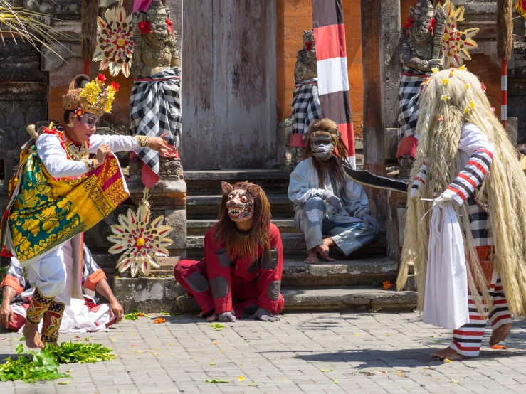 some people in costume on the steps next to a building