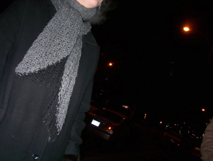 a person wearing a gray and black scarf