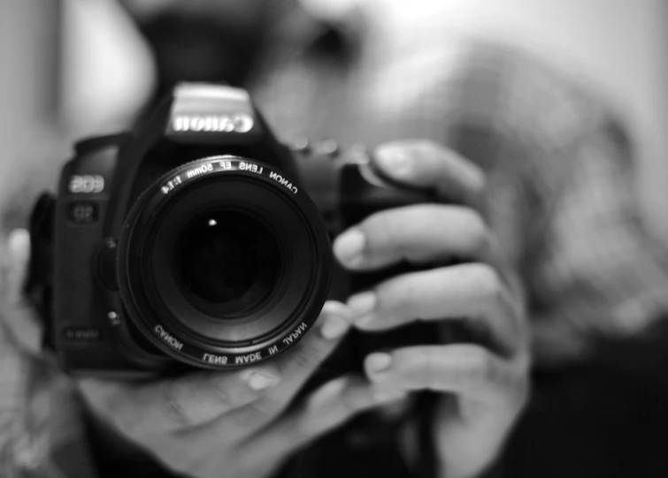 a person holds a camera in front of their face