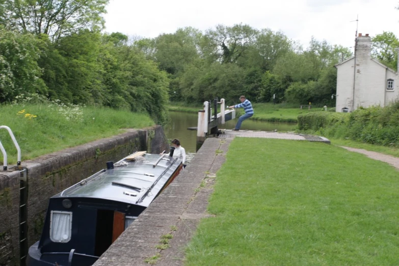 a person climbs down the side of a boat ramp