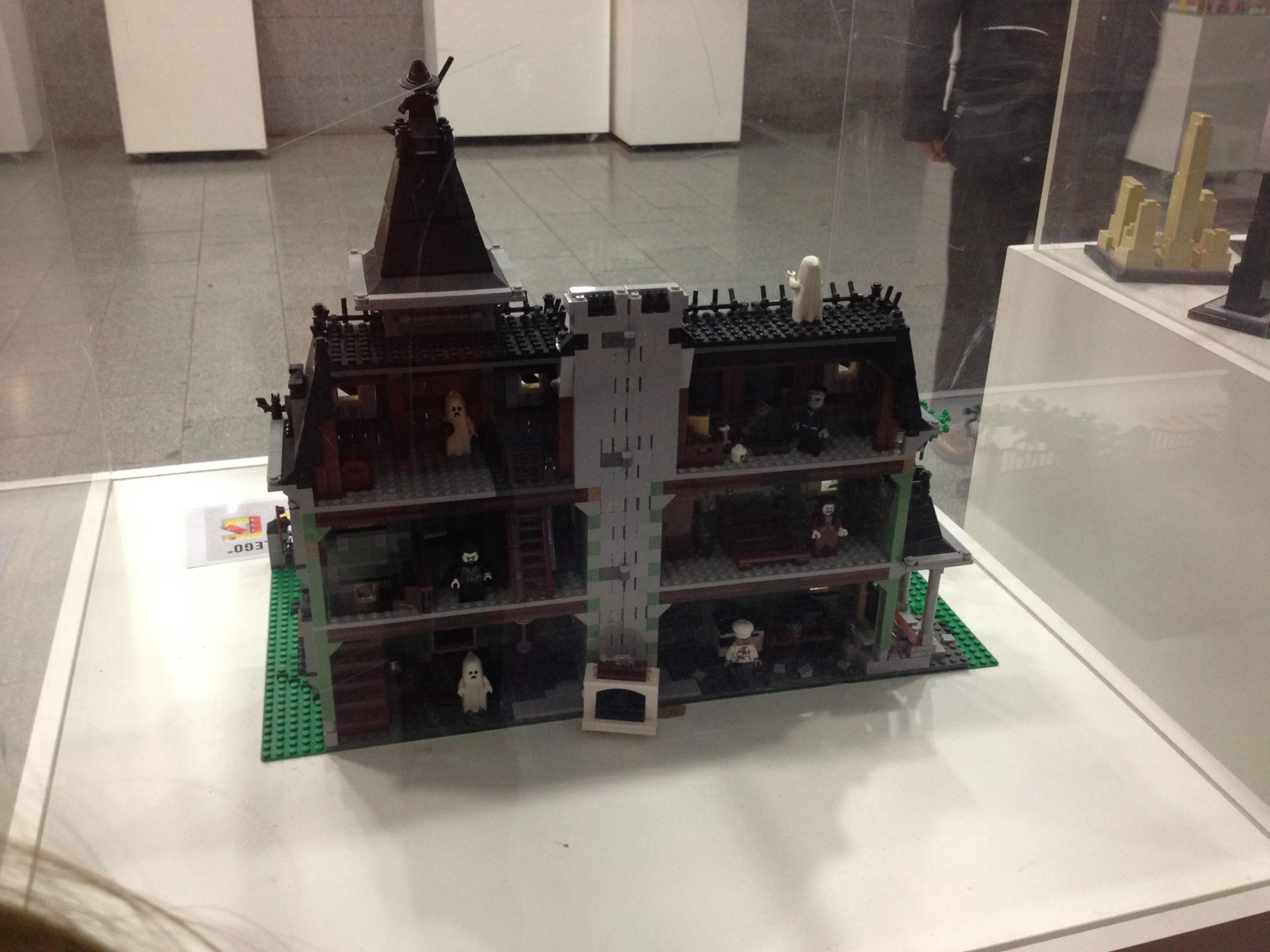 a model of a castle building with figurines on display