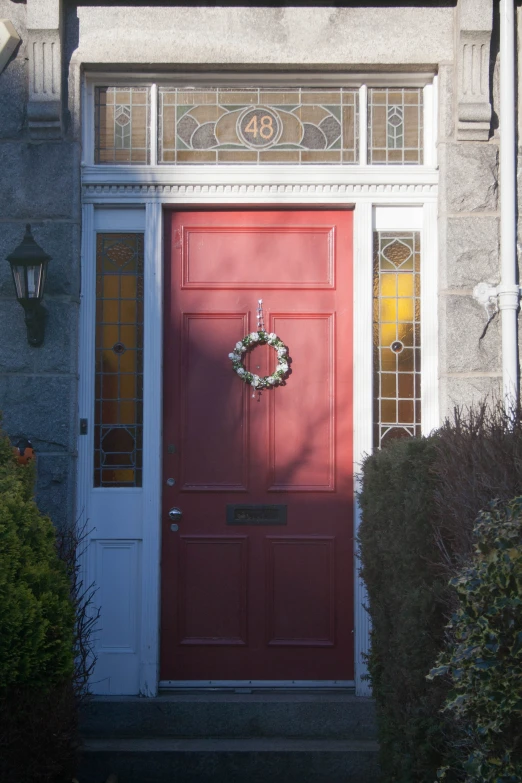 a red door with a wreath on it