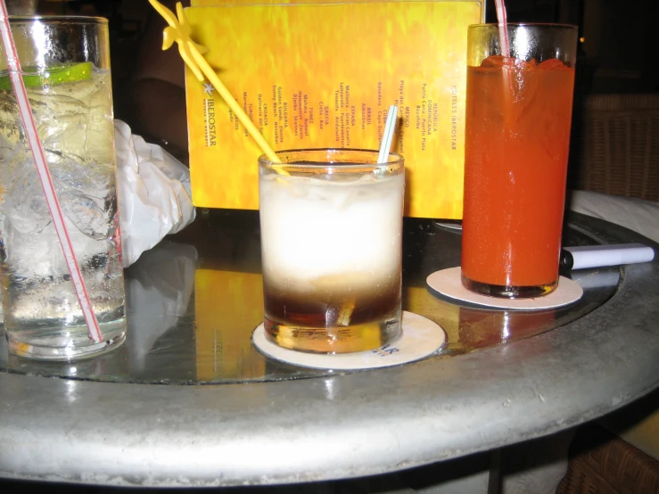 a table with drinks and an card that says the book of life