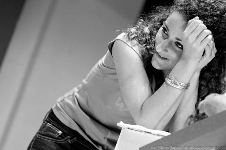 black and white pograph of a woman holding her head in her hands