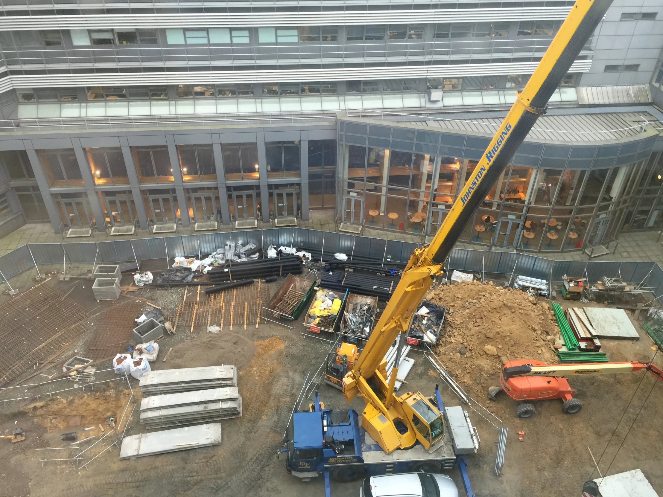 a crane is in the air on top of a construction site