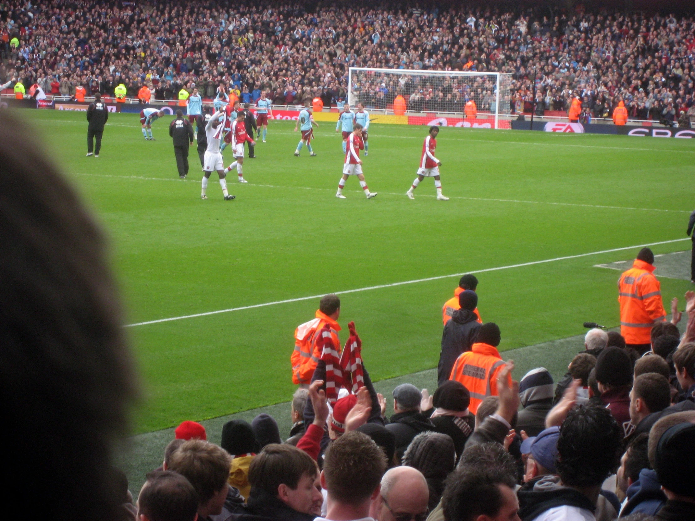 a number of men playing soccer on a field