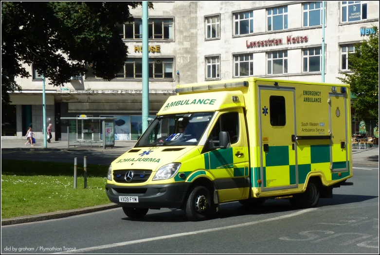 an ambulance with the doors open and a green checkered stripe