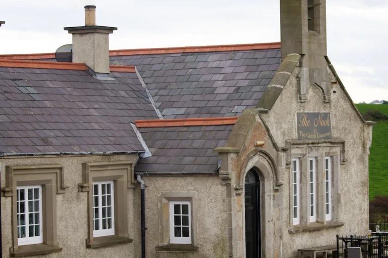 old, stone building with brick chimneys and windows