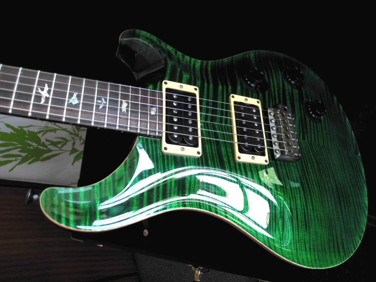 a green guitar with white and black patterns on it