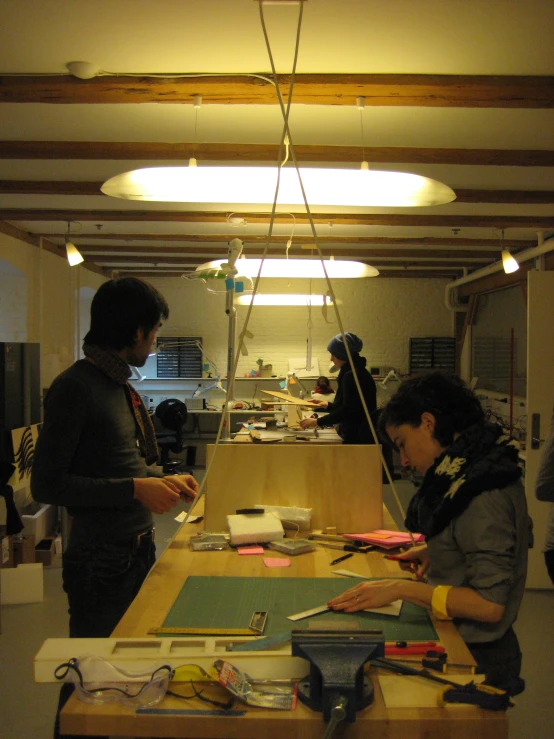 two women working on crafts at an art project