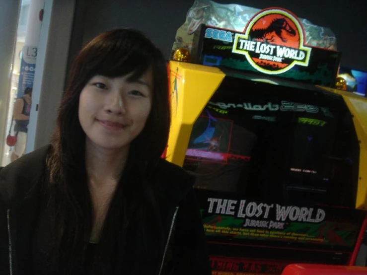 the woman is posing for a picture in front of the slot machines