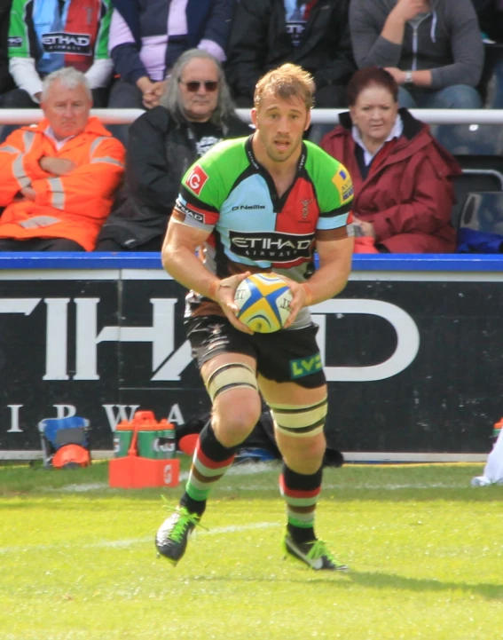 a man running with the ball at an event