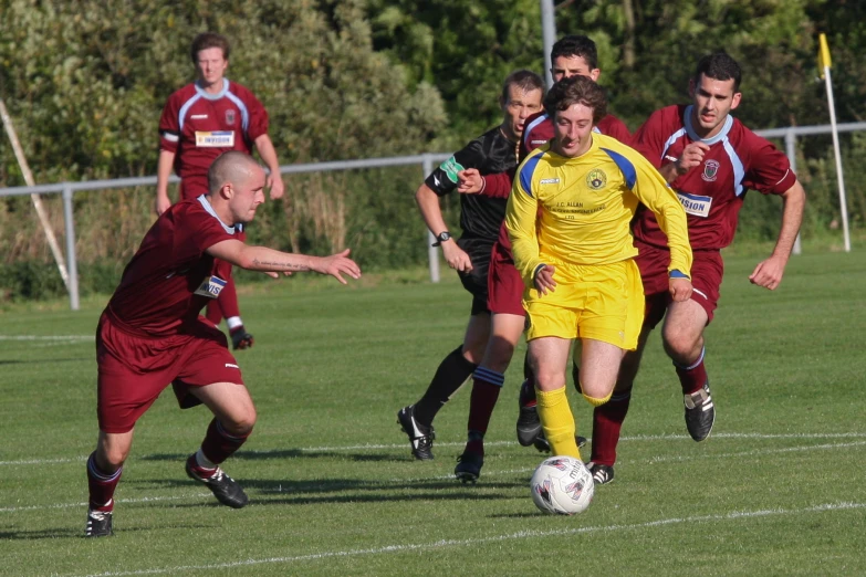 a group of young men playing soccer against each other