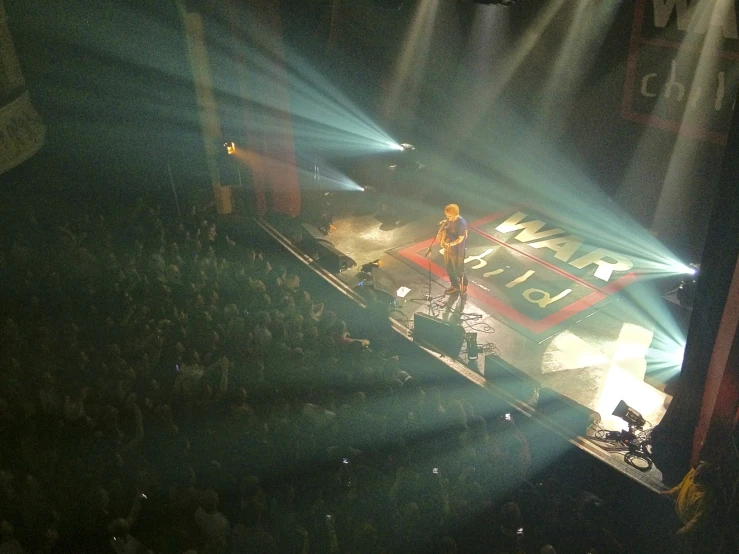 two people singing on stage at a concert