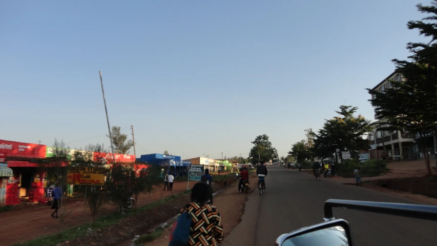 a group of people walking down the street next to a truck