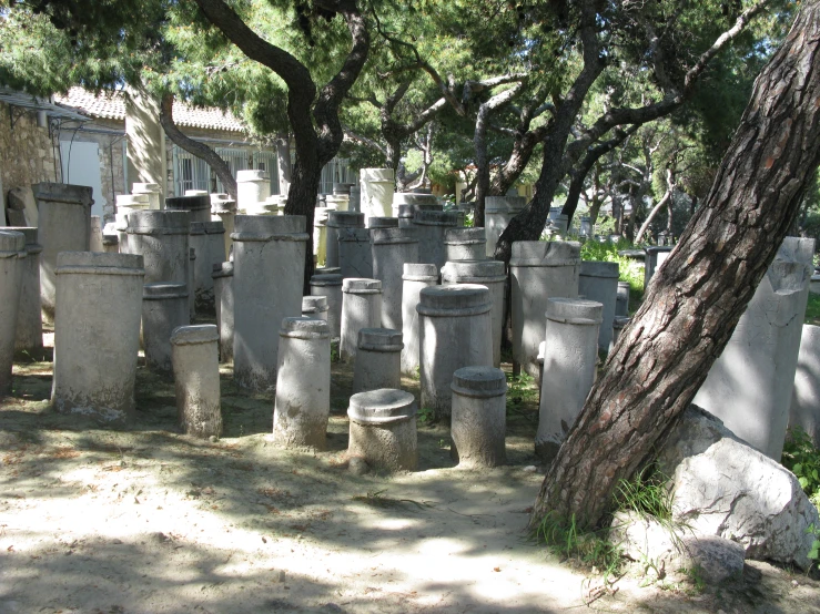 a cemetery in a wooded area with many tombstones and trees