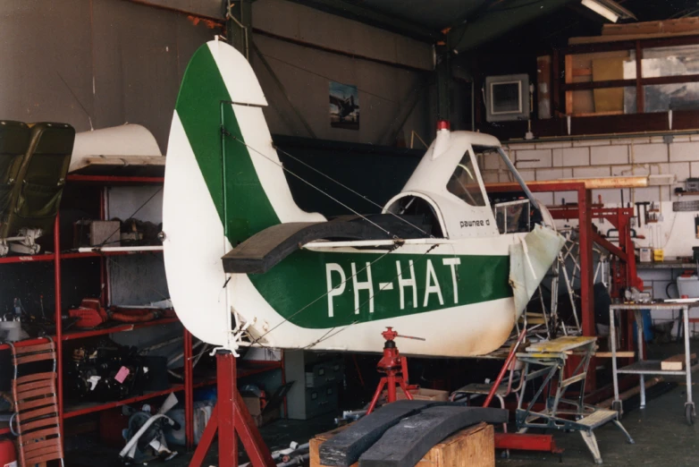 a boat sits in a building where parts are being stored