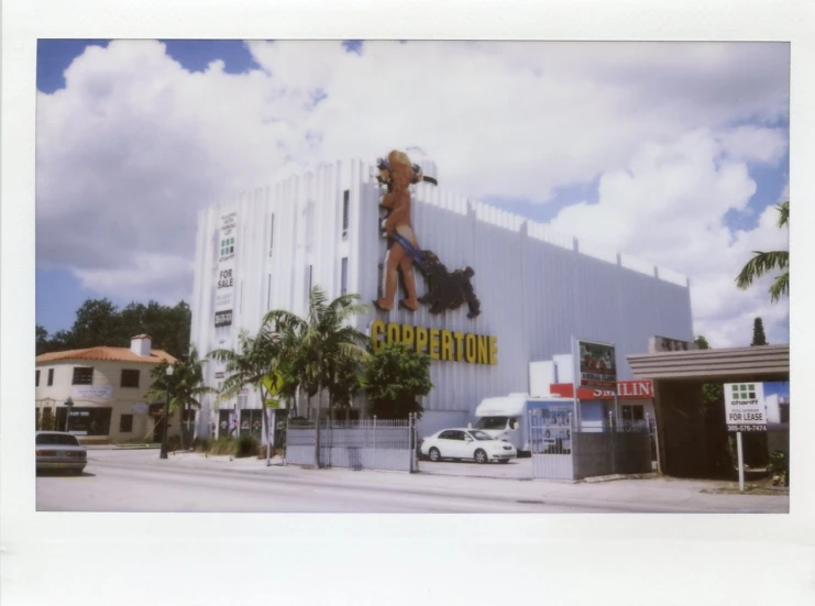 a building with a lot of signs and parked cars