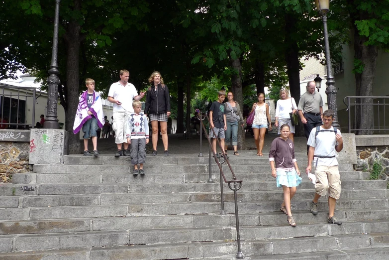 there is a group of people walking up the steps