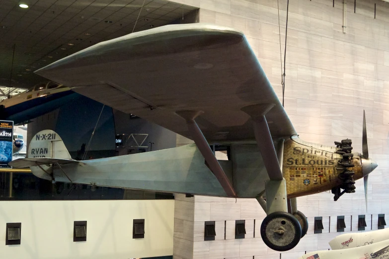 a large airplane hanging from the side of a building