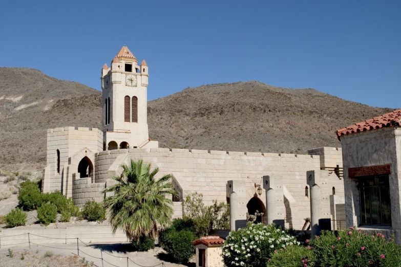 an old stone church stands near mountains